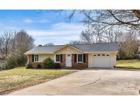 Charming single-story home with brick accents, well-maintained lawn, and attached garage at 155 33Rd Nw St, Hickory, NC 28601