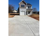 Charming two-story home with light siding, garage and a concrete driveway at 195 Bethesda Rd, Statesville, NC 28625