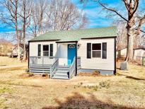Charming single-story home with a blue front door and a gray porch and matching shutters at 2123 Ravendale St, Kannapolis, NC 28083