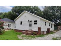 Cozy single-story home with white siding, brick foundation, well-kept lawn, and mature trees at 2328 Milton Ave, Gastonia, NC 28052