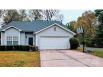 Charming single-Gathering home with a two-car garage, a basketball hoop, and mature landscaping at 2345 Nuthatch Dr, Rock Hill, SC 29732