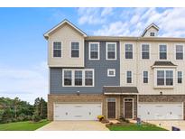 Charming townhome exterior showcases a mix of stone and siding accents, complemented by a well-manicured lawn and double-car garage at 4387 Reed Creek Dr, Sherrills Ford, NC 28673