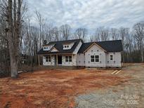 New construction home featuring a classic roofline, large windows, and a brick foundation, set on a spacious lot at 601 Shiloh Unity Rd, Lancaster, SC 29720