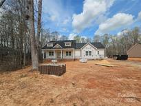 New construction home featuring a welcoming front porch and a classic black roof, set on a spacious lot at 601 Shiloh Unity Rd, Lancaster, SC 29720