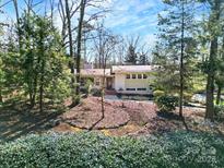 Inviting single-story home with mature trees and lush landscaping at 725 Skytop Rd, Waxhaw, NC 28173