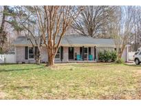 Charming brick home with a well-manicured lawn and inviting front porch at 781 Niblick Dr, Gastonia, NC 28054