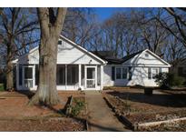 Charming single-Gathering home featuring a screened-in porch and landscaped front yard at 802 Lewis St, Gastonia, NC 28054