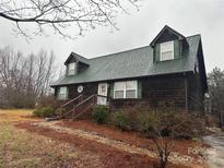 Charming log cabin-style home with green shutters and a well-maintained front yard at 109 Unity Church Rd, Kings Mountain, NC 28086