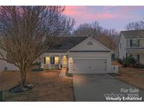 Charming single-Gathering home with a front porch, manicured lawn, and a two-car garage at 117 Peterborough Dr, Mooresville, NC 28115