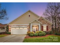 Charming single-Gathering home featuring a stone and siding exterior with a well-manicured front yard at 1209 Waypoint Ct, Matthews, NC 28104