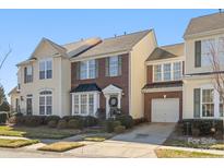 Charming townhome with brick and siding exterior, manicured landscaping, and a welcoming entrance at 14622 Greenpoint Ln, Huntersville, NC 28078