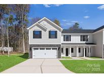 Charming townhouse showcasing a two-car garage, a manicured lawn, and light grey and white siding at 1608 Breezewood Dr, Charlotte, NC 28262