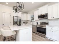 Modern kitchen features stainless steel appliances and white cabinetry at 1608 Breezewood Dr, Charlotte, NC 28262