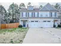 Charming townhome featuring attached garages, well-maintained lawn and gray accented shutters at 203 Makayla Ct, Fort Mill, SC 29715