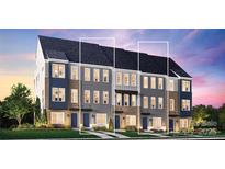 Beautiful new townhome exterior featuring brick, siding, and a well-maintained lawn at 2039 Clarksdale St # 32, Charlotte, NC 28206
