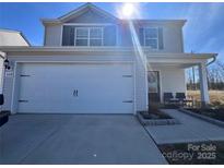 Inviting two-story home featuring a spacious two-car garage and manicured landscaping at 329 Aniston Ln, Shelby, NC 28152