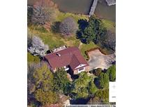 Aerial view of a waterfront home with a red roof, dock, and mature trees at 4220 Honeysuckle Rd, Rock Hill, SC 29732
