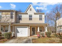 Charming townhome featuring a covered porch, one car garage and neutral-toned siding at 471 Doughton Ln, Charlotte, NC 28217