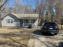 Charming one-story home with a cozy front porch, mature trees, and a paved driveway at 534 Fairbluff Ave, Salisbury, NC 28146