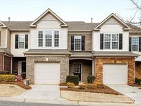 Charming townhome with a one-car garage and well-maintained landscaping at 6449 Silver Star Ln, Charlotte, NC 28210