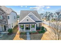 Charming single-Gathering home with a welcoming front porch, complemented by well-maintained landscaping at 7035 Walnut Branch Ln, Charlotte, NC 28277