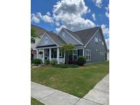 Charming single-Gathering home featuring a covered front porch, well-maintained lawn, and beautiful landscaping at 7035 Walnut Branch Ln, Charlotte, NC 28277