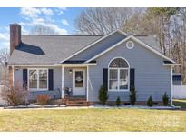 Charming single-story home featuring gray siding, black shutters, brick chimney and a welcoming front porch at 110 Weeping Willow Way, Gastonia, NC 28052