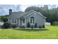 Charming single-story home with gray siding, well-maintained lawn and a classic brick chimney at 110 Weeping Willow Way, Gastonia, NC 28052
