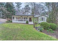 Charming single-story home with a welcoming front porch and well-maintained lawn at 121 Wonderwood Dr, Charlotte, NC 28211