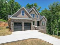 Beautiful, new two-story brick home featuring an attached two-car garage and concrete driveway at 240 Mark Ryan Ln, Dallas, NC 28034
