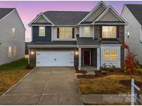 Charming two-story home with brick accents, a two-car garage, and a well-manicured lawn at 3064 Virginia Trail Ct, Fort Mill, SC 29715