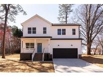 Charming two-story home featuring a bright blue front door, black garage door, and inviting front porch at 119 Ethel Dr, Stanley, NC 28164