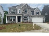 Charming two-story home with stone accents, a front porch, and a two-car garage at 173 Glenn Dr, Mooresville, NC 28115