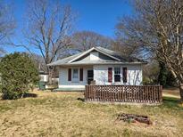 Charming home featuring a small porch, red shutters, and a quaint yard on a sunny day at 2040 S Marietta St, Gastonia, NC 28054
