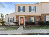 Charming townhome featuring a brick facade, blue shutters, and a well-manicured front yard at 2705 North Center St # 6, Hickory, NC 28601