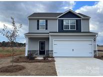Charming two-story home featuring a two-car garage, stone accents, and a well-manicured front lawn at 3430 Saddlebred Dr, Gastonia, NC 28052