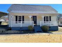Charming single-story home with inviting front porch and meticulously maintained front lawn at 3481 Roberta Rd, Concord, NC 28027