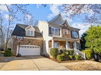Charming two-story home with a brick and stone facade, well-manicured lawn, and attached two-car garage at 437 Buttermere Rd # 31, Fort Mill, SC 29715