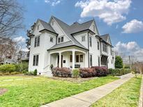 Charming two-story home with landscaped yard, porch swing and beautiful curb appeal at 700 Clement Ave, Charlotte, NC 28204