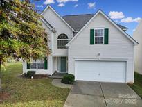 Charming two-story home with a two-car garage, landscaped yard, and welcoming front entrance at 868 Coach House Ct, Rock Hill, SC 29730