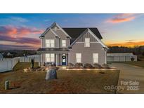 Charming two-story home with a manicured front yard and welcoming front porch at twilight at 1010 Coppergate Dr, Salisbury, NC 28147