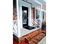 Inviting brick front entrance with classic white trim and a secure black door at 109 Stroupe Rd # E, Gastonia, NC 28056