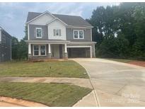 Charming two-story home with a spacious driveway and a mix of stone and gray siding at 177 Glenn Dr, Mooresville, NC 28115