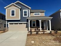 Two story home featuring attached two car garage and covered entryway at 2616 Tillman St, Monroe, NC 28112