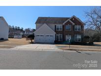 Charming two-story home featuring a brick facade, double garage, and well-maintained landscaping at 279 Age Old Way, Rock Hill, SC 29732