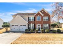 Charming two-story home with a brick facade, well-manicured landscaping, and a two-car garage at 279 Age Old Way, Rock Hill, SC 29732