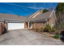 Inviting exterior of a home, showing a two-car garage and stone and brick facade at 2941 Bellasera Way, Matthews, NC 28105