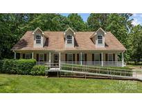 Charming one-story home with a welcoming front porch and manicured lawn provides easy access with included ramp at 3039 Paraham S Rd, York, SC 29745