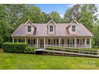 Inviting one-story home with charming front porch,dormers,ramp access, and well-manicured lawn at 3039 Paraham S Rd, York, SC 29745