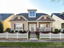 Charming single-Gathering home featuring a white picket fence, covered porch, and well-maintained landscaping at 1012 Preakness Blvd, Indian Trail, NC 28079